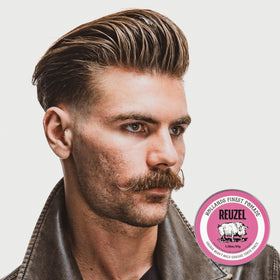Hands applying REUZEL Pink Grease to hair for smooth styling control
