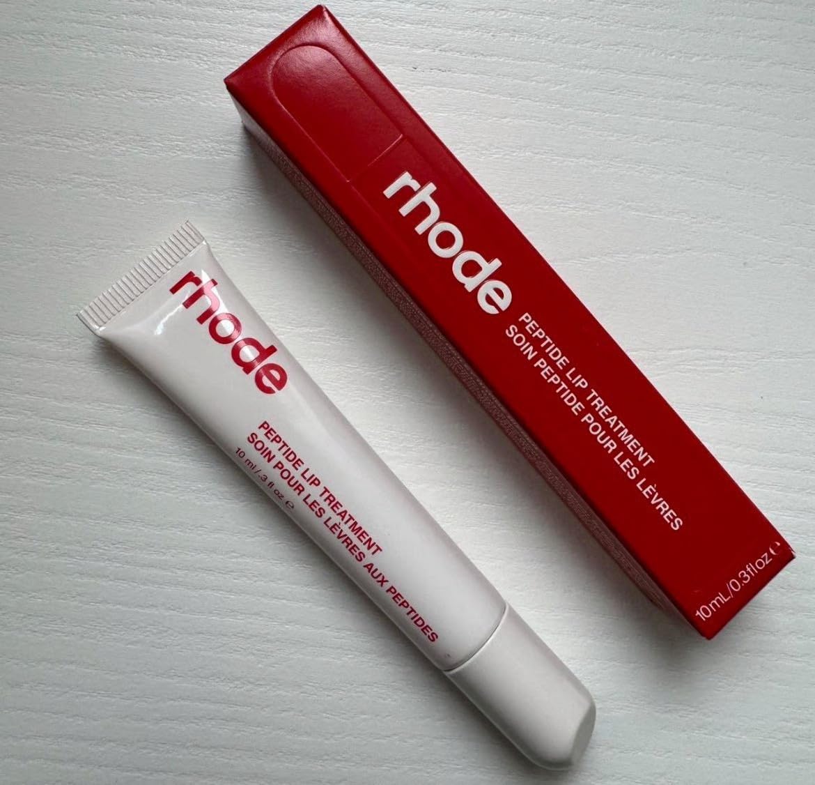 Rhode Lip Treatment Strawberry Glaze bottle delivers hydration with a glossy finish