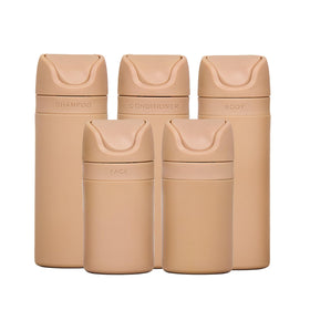 RIES essential refillable toiletry bottles set in sand, airless pumps reduce leaks during travel