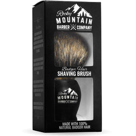 Rocky Mountain Barber premium shaving kit display with brush and stand.