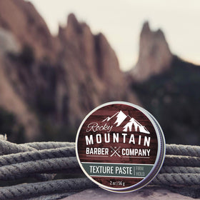 Rocky Mountain Barber Company two-ounce tin shown for travel-friendly styling.
