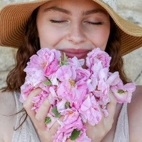 Silky rosewater in a glass bottle, luxurious sensory experience.