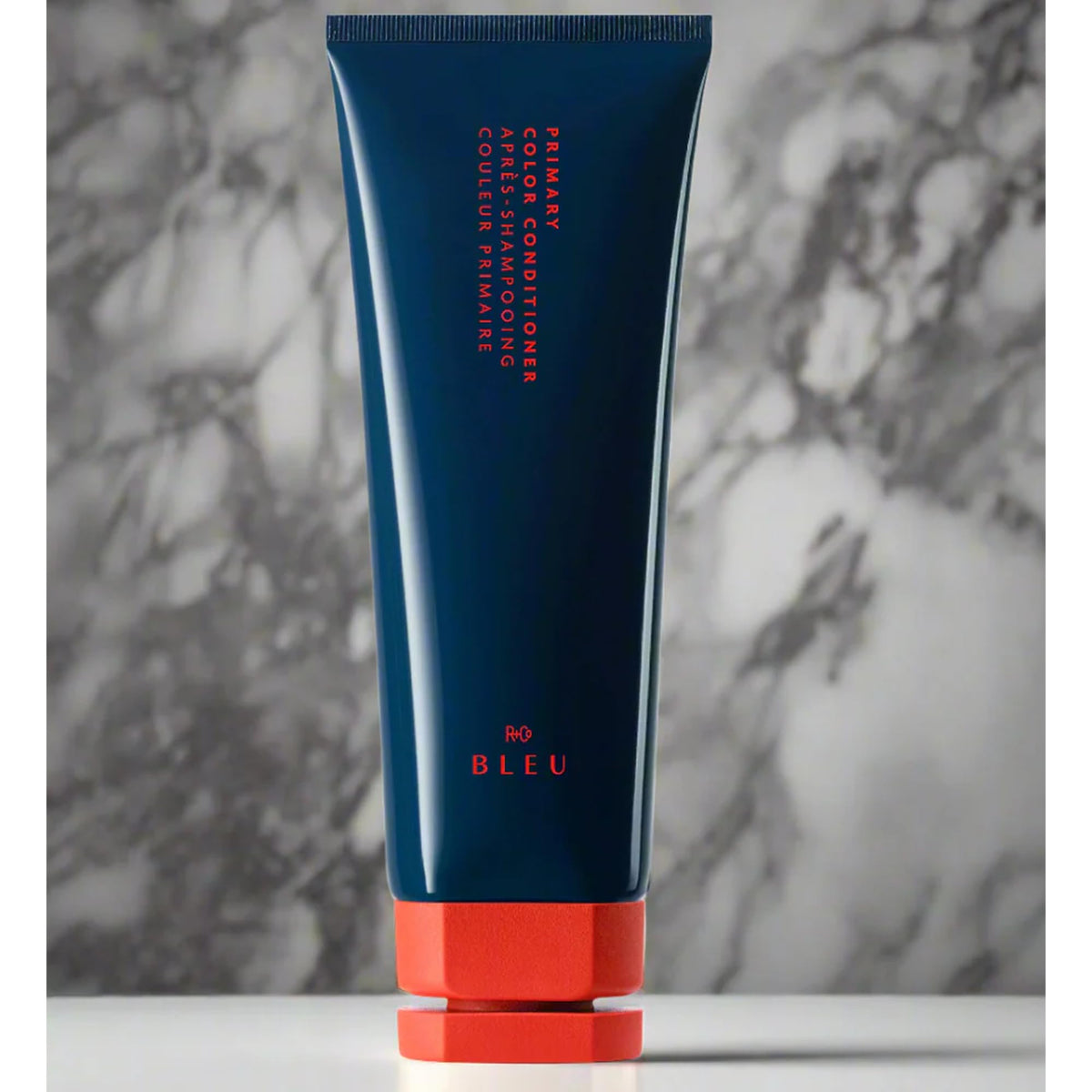 R+Co BLEU conditioner application on hair smooths and seals the cuticle