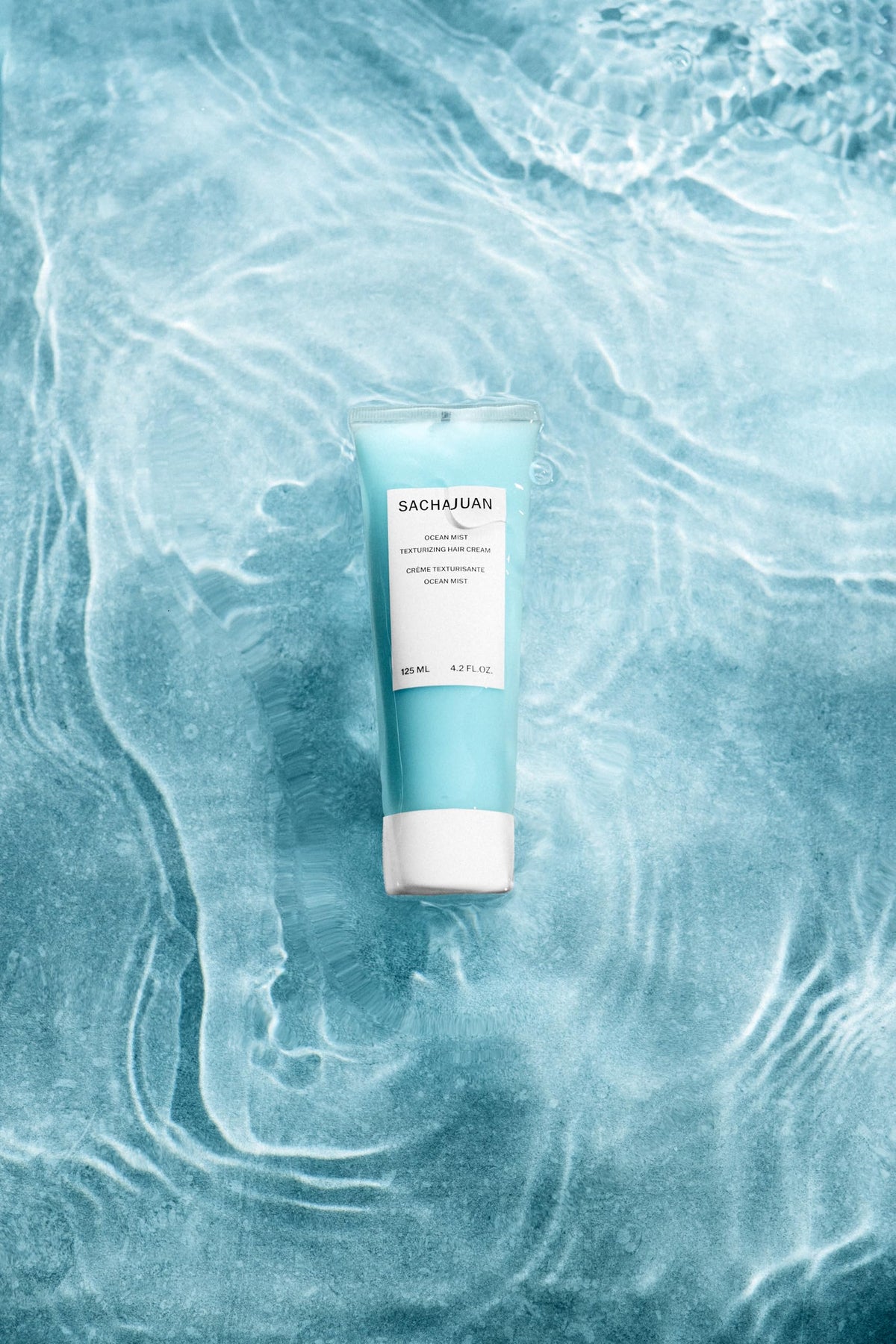 SACHAJUAN Ocean Mist being applied by hands to create texture.