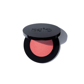 Saie Glow Sculpt Peachglow compact showing warm pinky peach shade for a dewy glow.