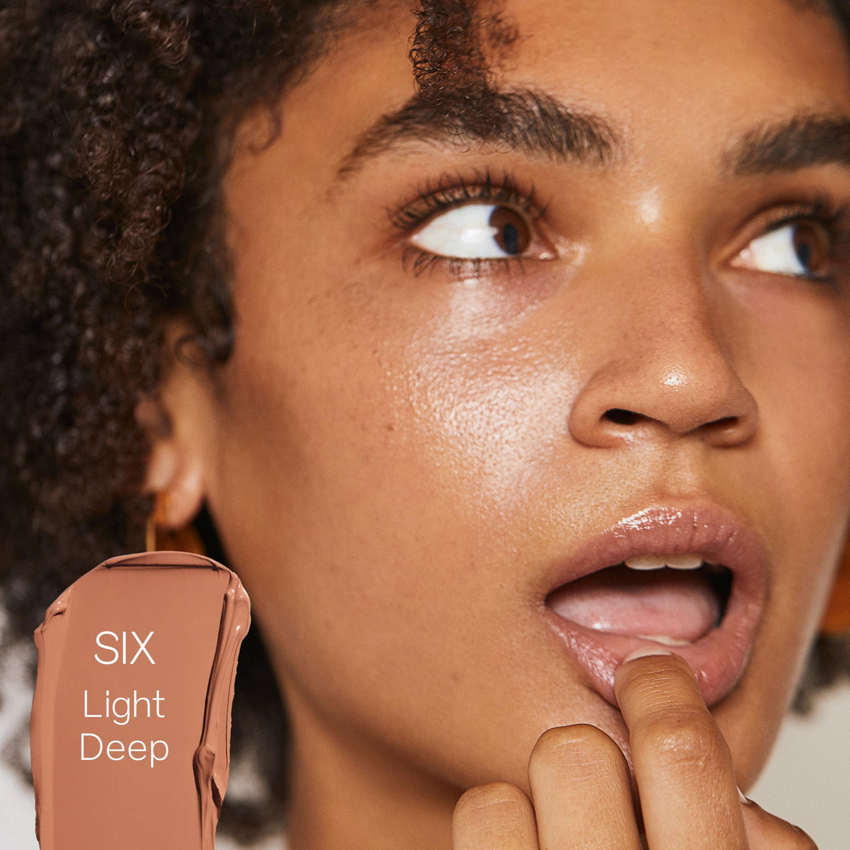 Saie Slip Tint glow finish swirl highlighting radiant, dewy skin texture
