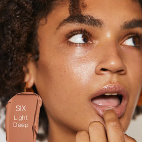 Saie Slip Tint glow finish swirl highlighting radiant, dewy skin texture