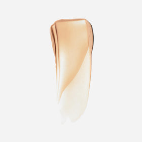 Saie Sunvisor golden pearl glow finish on skin for radiant dewy look