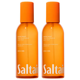 Saltair Body Mist 2-Pack bottles on a sunny beach for portable fragrance.