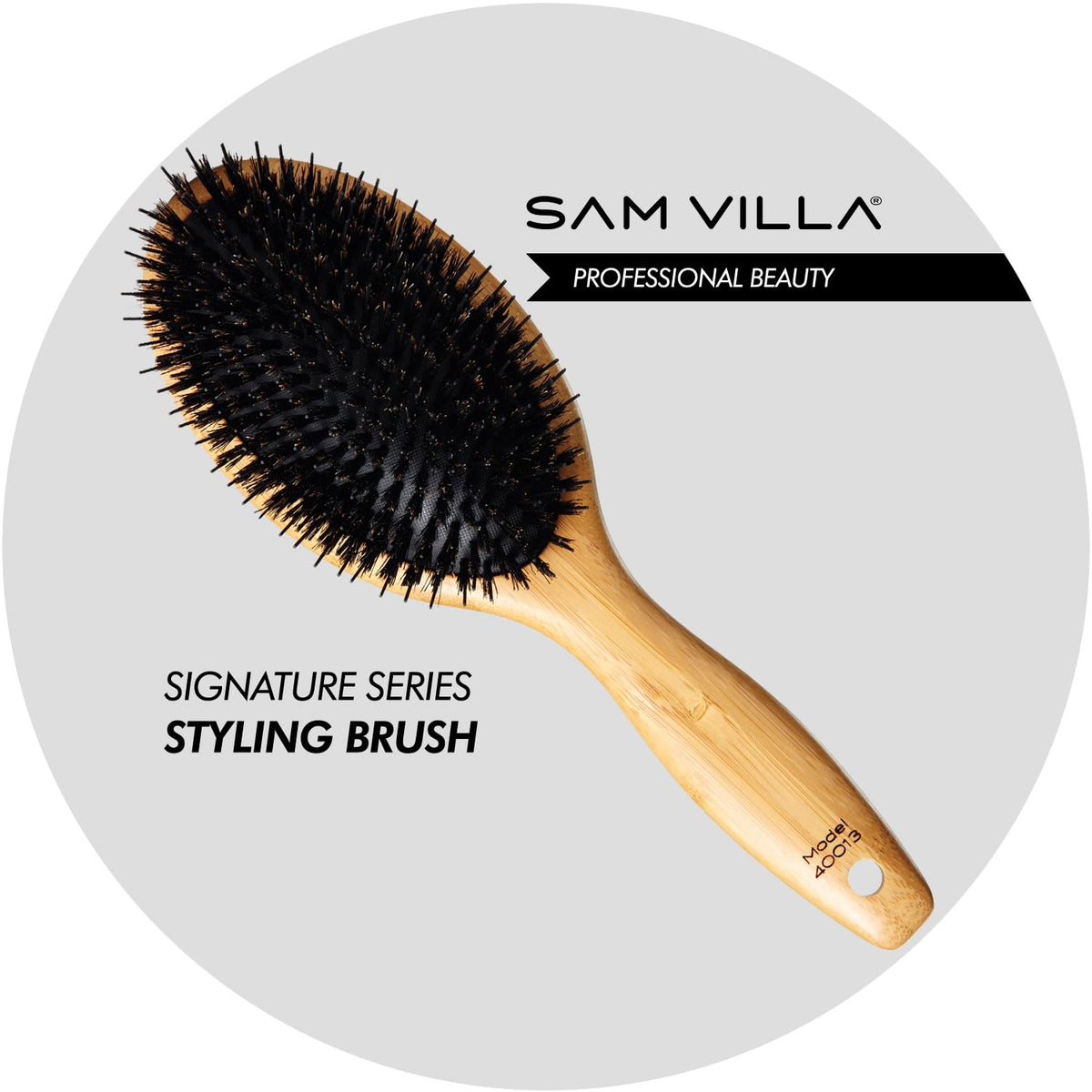 Sam Villa Signature Series boar bristle brush on hair for smoother brushing.