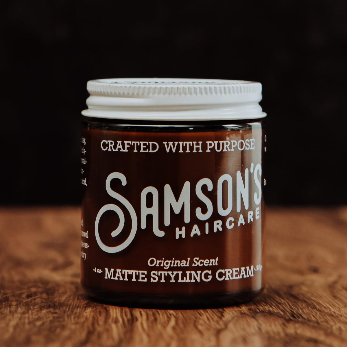 Hands applying SAMSON'S HAIRCARE Matte Styling Cream for versatile styling without shine.