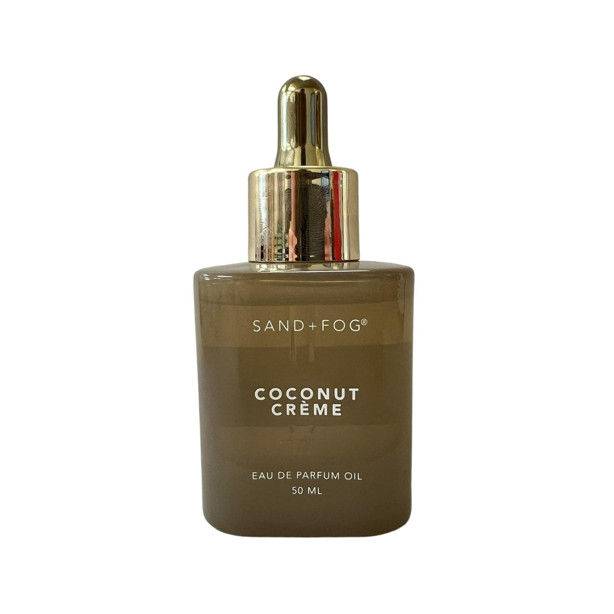 Sand + Fog Coconut Creme Eau De Parfum Oil bottle, ideal for subtle, long-lasting coconut scent.