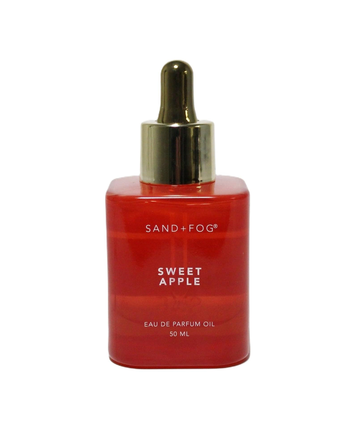 Sand + Fog Sweet Apple Oil in a red bottle with a gold dropper cap, long-lasting fragrance.