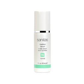 Sanitas VitaRich Serum bottle pour demonstrates hydrating, antioxidant-rich care for radiant skin.