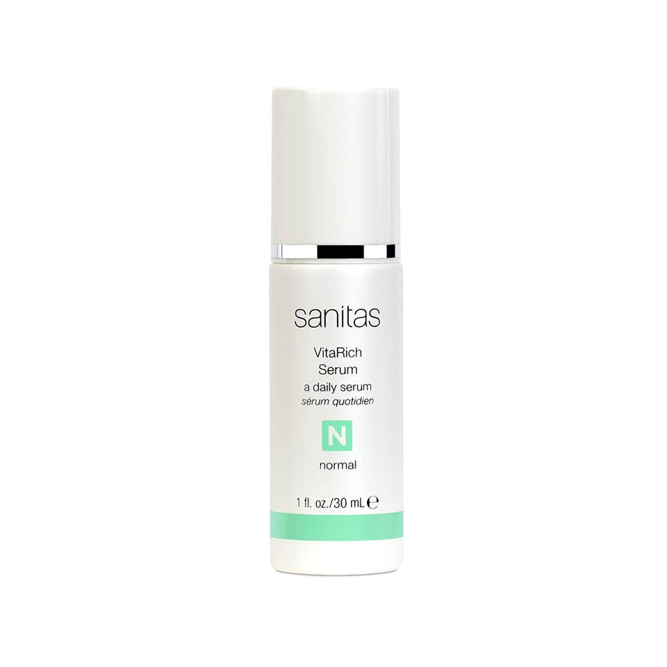 Sanitas VitaRich Serum bottle pour demonstrates hydrating, antioxidant-rich care for radiant skin.