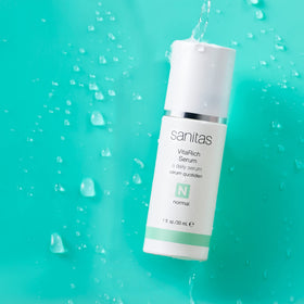 Sanitas VitaRich Serum texture swirl highlights nourishing vitamins for a brighter complexion.