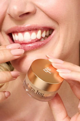 Applying Sara Happ Lip Scrub to lips for prep and hydration