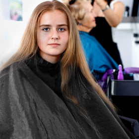 SATINIOR lightweight cape providing comfortable coverage in a home salon