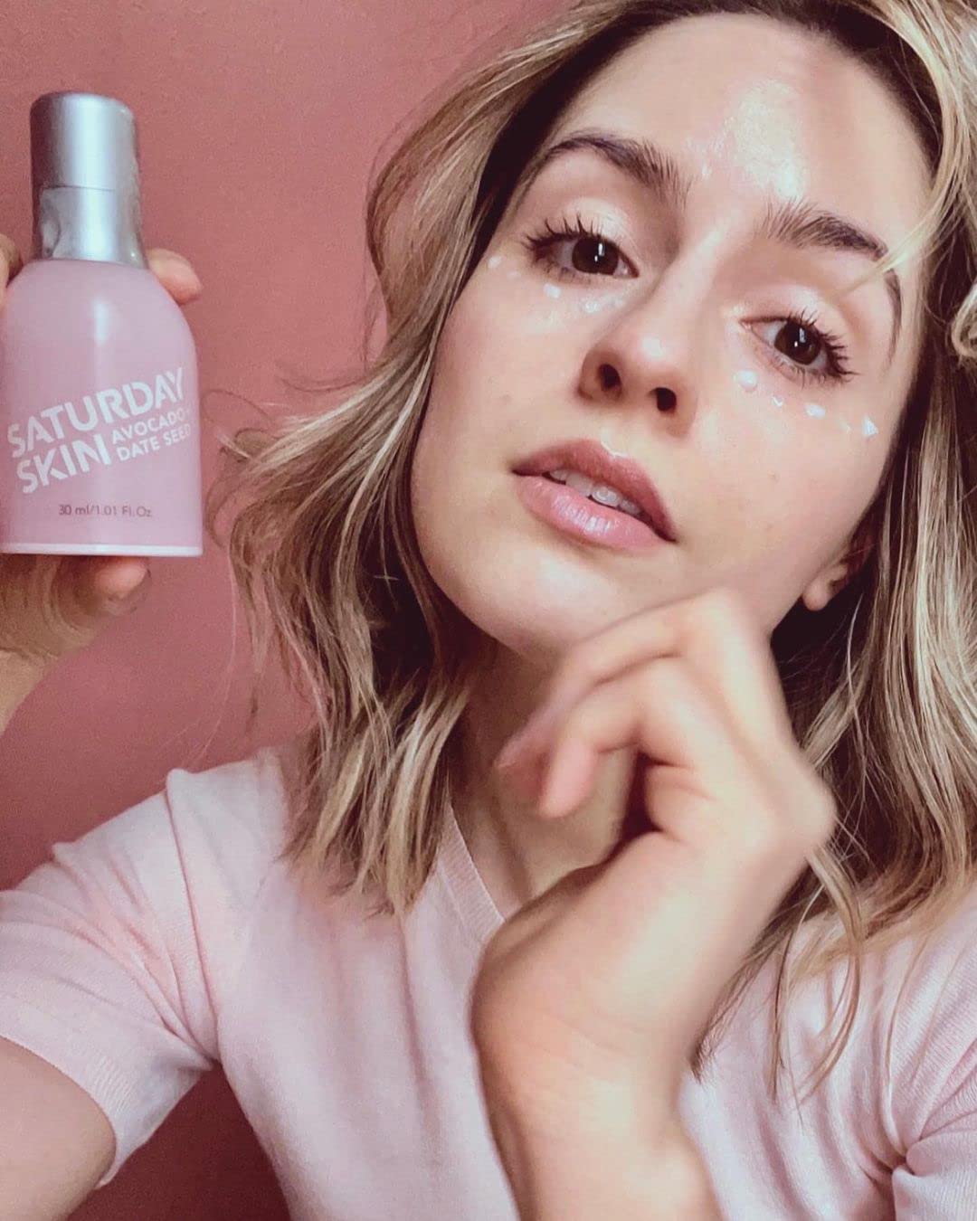 Dosing the Saturday Skin Wide Awake Eye Cream with a pea-sized amount for application.