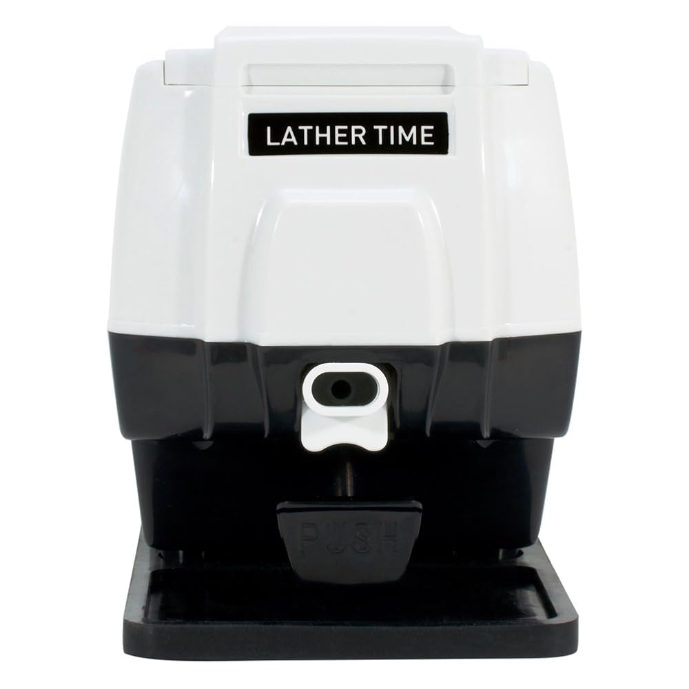 Close-up of the dispensing button on Scalpmaster Pro hot lather machine