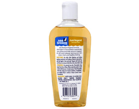 Seabreeze Astringent applied with cotton pad on face and neck for cleansing.