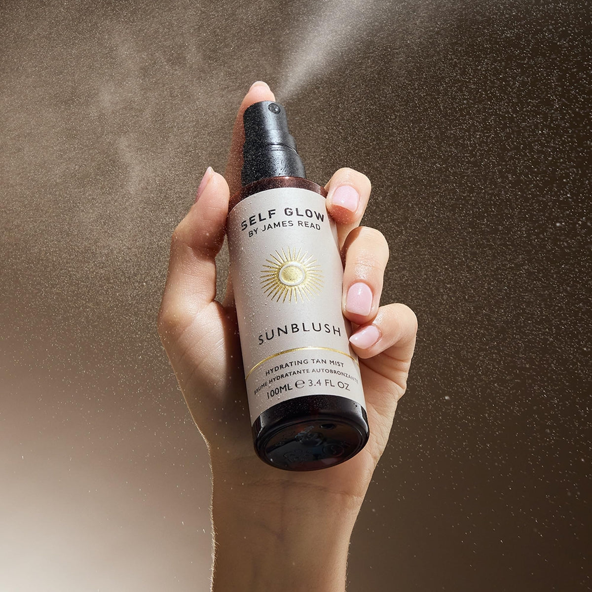 Self Glow by James Read face and neck mist for even coverage.