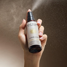 Self Glow by James Read face and neck mist for even coverage.