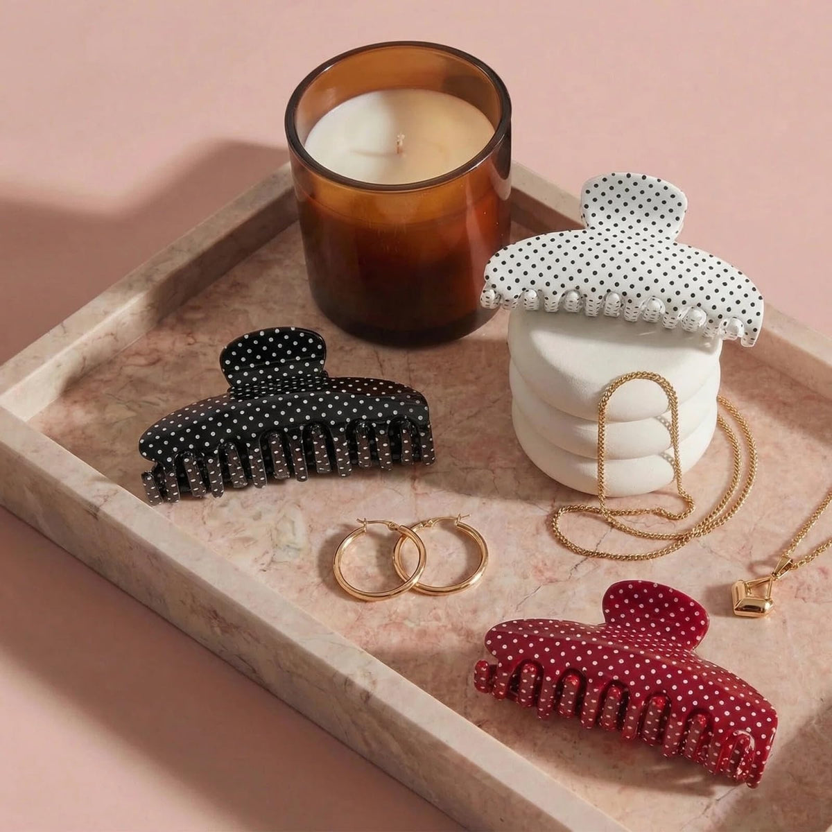 Black polka dot clip close-up highlighting strong grip for all hair types.