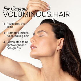 Serovital serum dropper dispensing two drops onto the scalp for use.