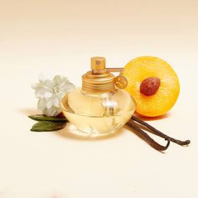 Shakira S spray bottle mid-air release suggesting lasting scent