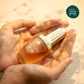 Shankara Kumkumadi Oil amber glass bottle highlights 32 flowers for nourishing glow.
