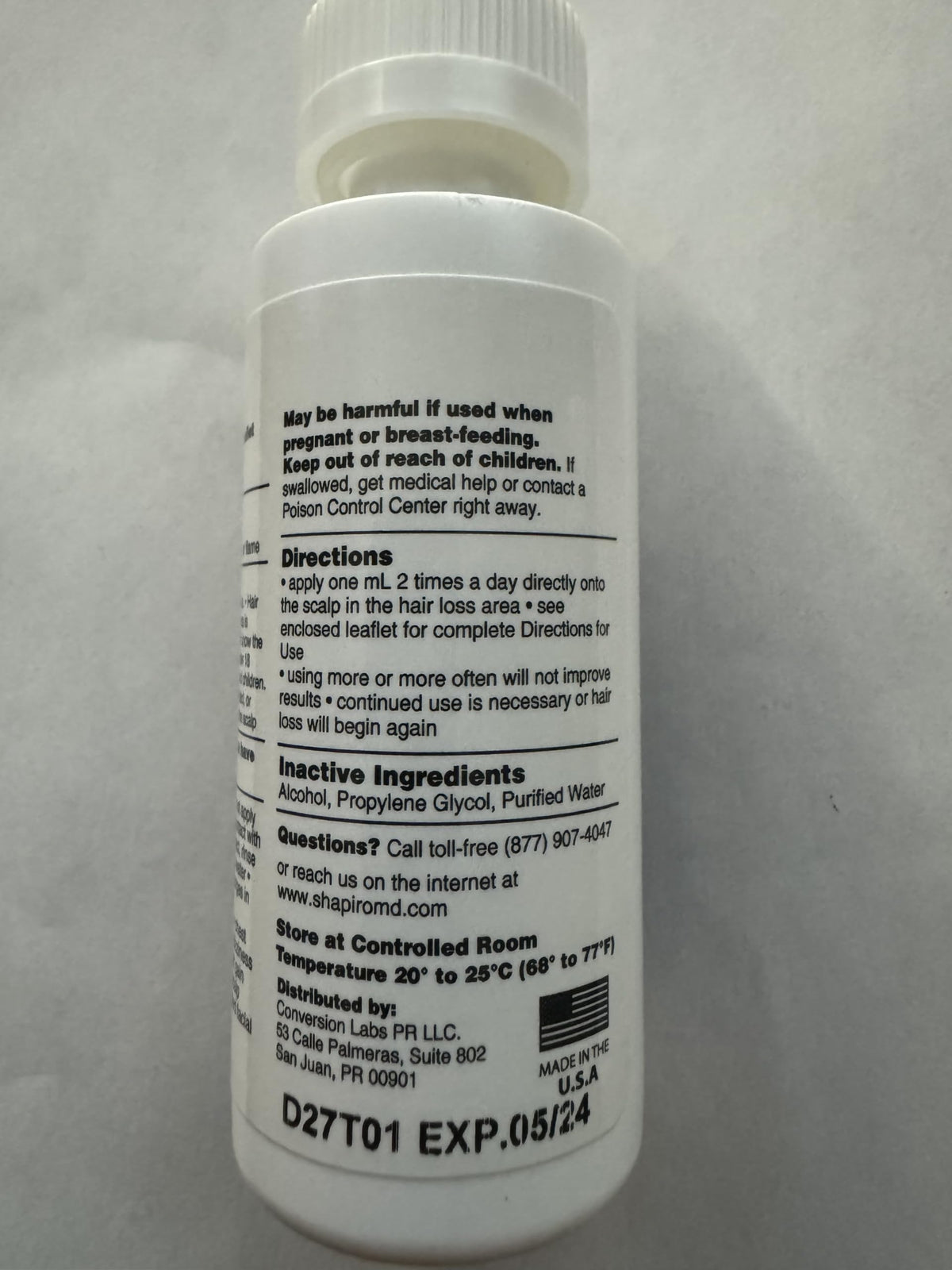 Close-up scalp view near Shapiro MD Minoxidil label, hinting at potential hair fullness support