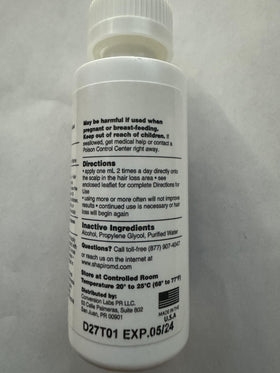 Close-up scalp view near Shapiro MD Minoxidil label, hinting at potential hair fullness support