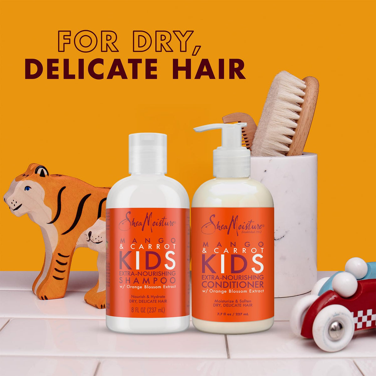 SheaMoisture Kids Coconut Hibiscus Detangler Spray bottle aiding detangling on curls