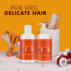 SheaMoisture Kids Coconut Hibiscus Detangler Spray bottle aiding detangling on curls