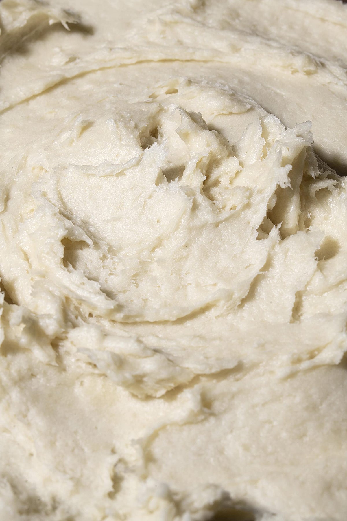 Hands applying Shea Radiance P U R E whipped butter for daily moisture