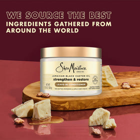 Applying SheaMoisture Leave-In Conditioner on towel-dried hair for smoother strands.