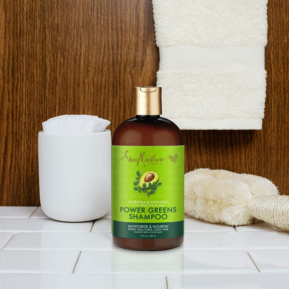 Creamy Power Greens conditioner coats tangled curls for smoother strands.