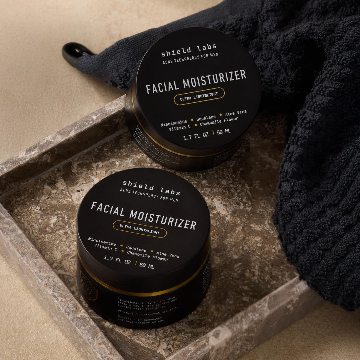 Two Shield facial moisturizer bottles ready for everyday use and travel
