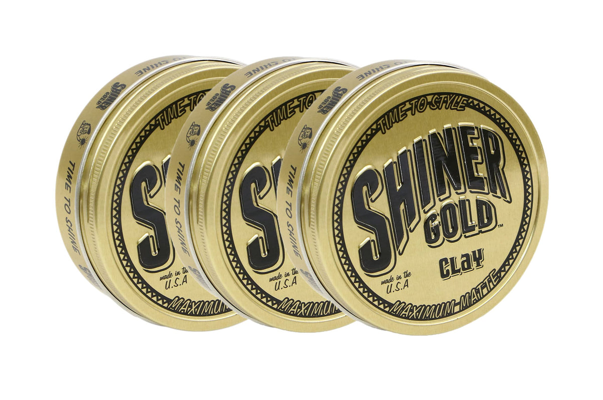 Shiner Gold Pomade bottle close-up highlighting strong hold and coconut scent.