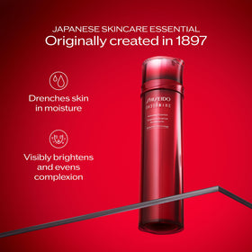 Applying Shiseido Eudermine Activating Essence to skin with fingertips for activation.