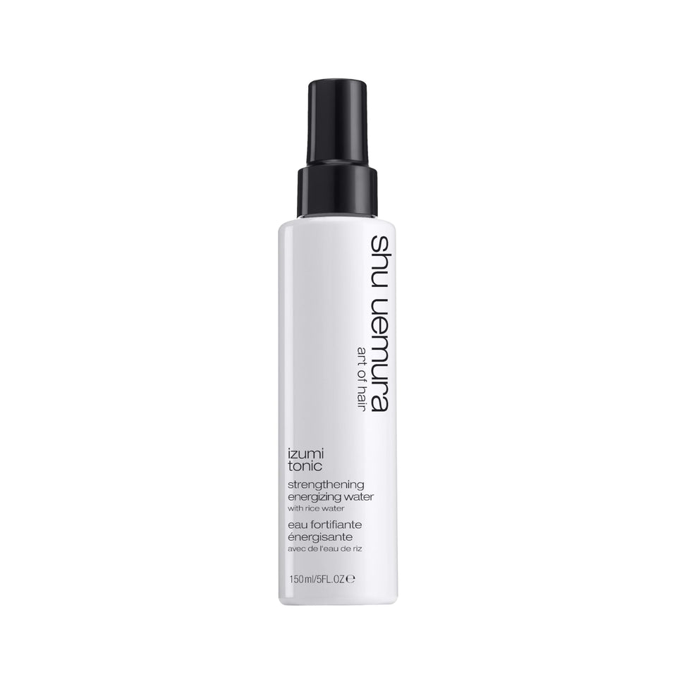 The shu uemura art of hair Izumi Tonic bottle close-up highlighting strengthening rice water benefits.