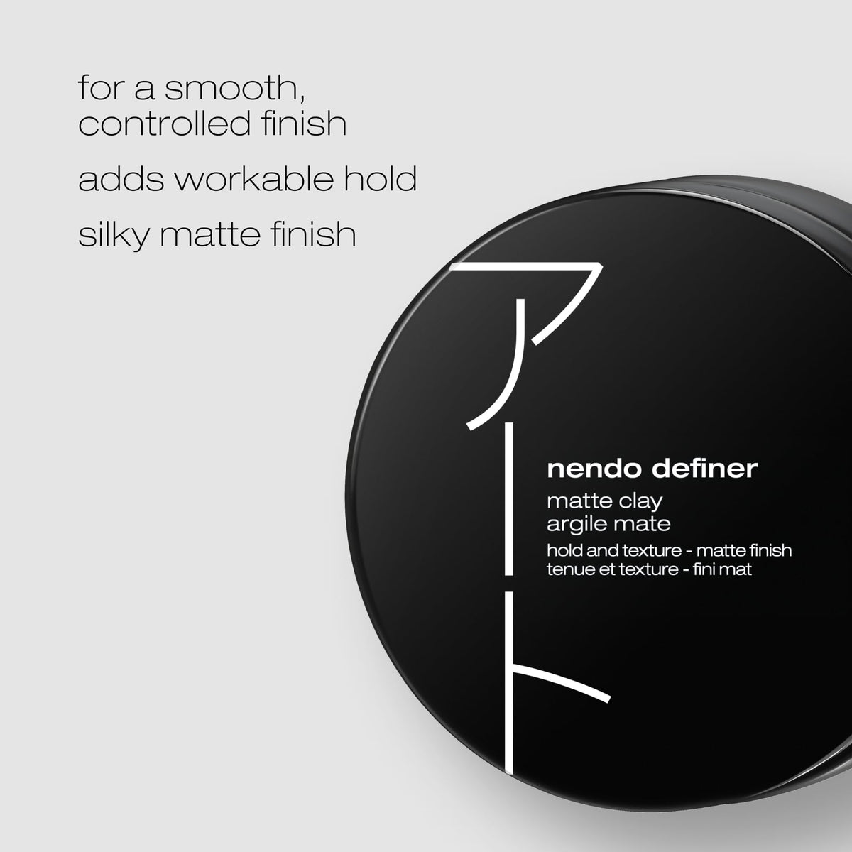 Close-up of Nendo Definer Pomade in hand shaping a textured look.