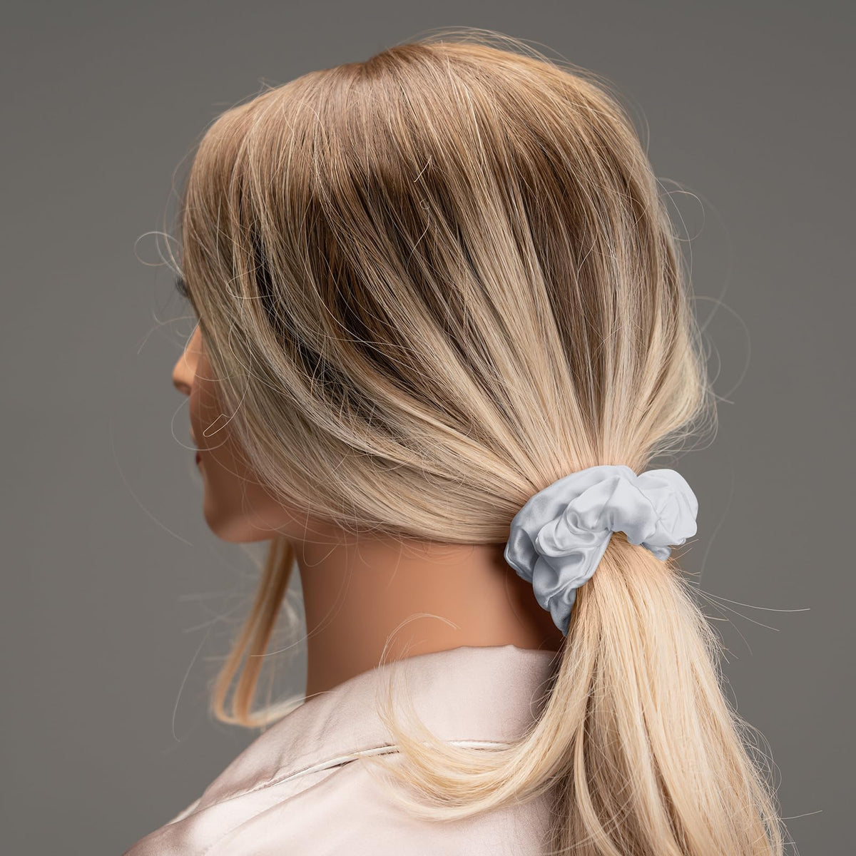 Silmer silk scrunchies wrapped around a bun for a soft updo