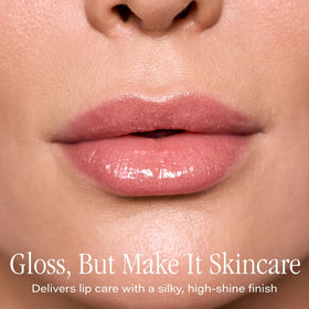 Close-up of SKINN Luminous Blush Lip Oil bottle showing Manuka honey and vitamin C benefits.