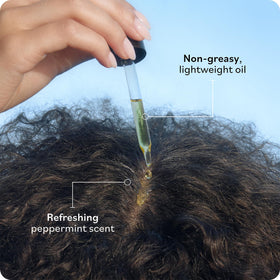 Hands applying Sky Organics Tea Tree oil to scalp for refresh
