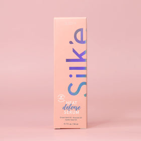Applying Sleek'e Silk'e serum to damp hair for frizz control and shine