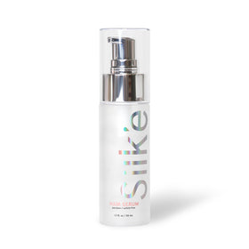Hands applying Sleeke Silk'e Serum to smooth frizz and add manageability.