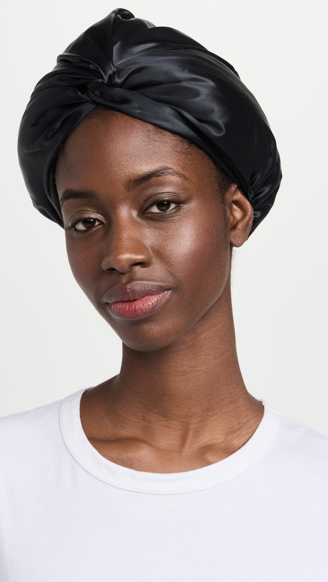 SLIP Pure Silk Turban Black on head at night emphasizes secure, comfortable fit.