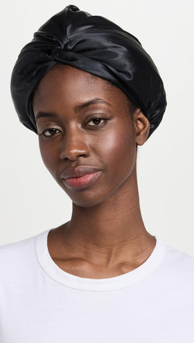 SLIP Pure Silk Turban Black on head at night emphasizes secure, comfortable fit.